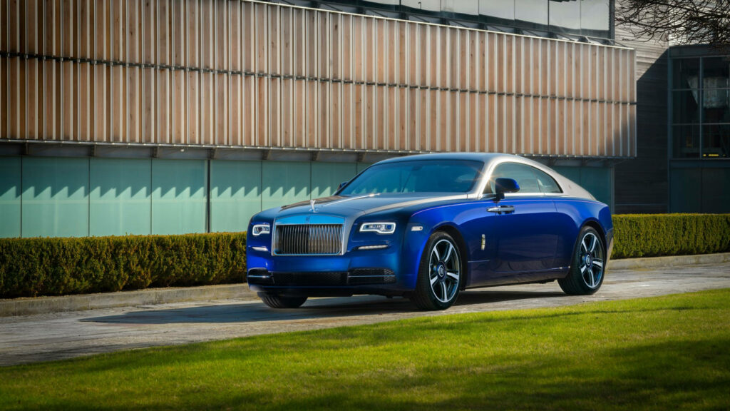 Rolls-Royce Wraith deep blue luxury car parked by manicured lawn modern building background 4K Wallpaper