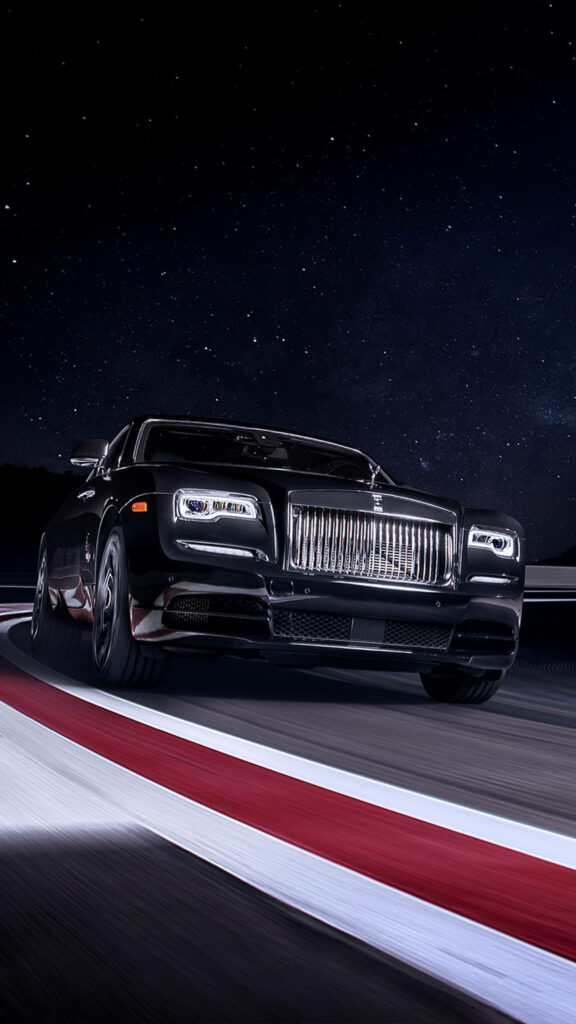 Rolls-Royce Wraith cruising on blurred night road under starry sky 4K luxury car wallpaper