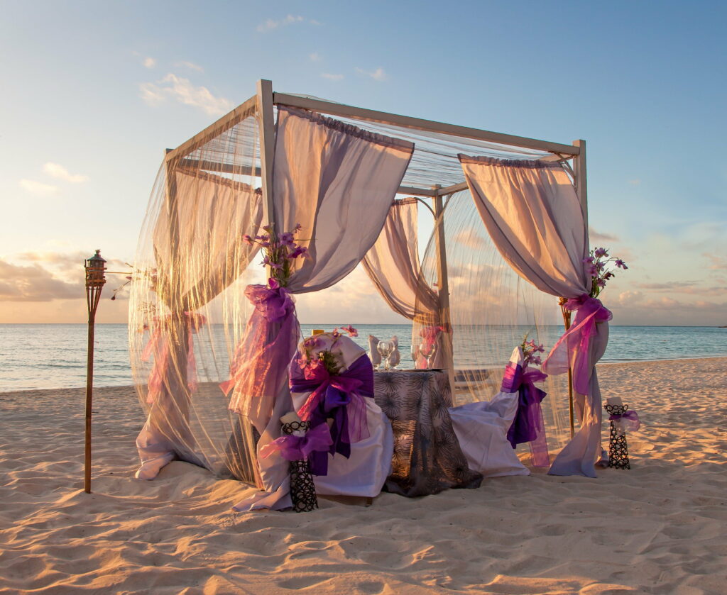 A Serenade by the Shore: A Romantic Torch-lit Exchange of Vows on a Beautiful Beach Setting Wallpaper
