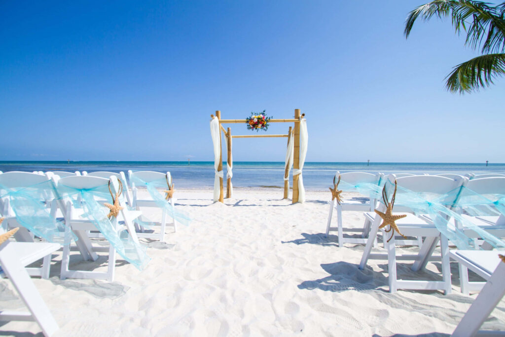 Romantic Beachfront Wedding Arch with Flowers and Ocean View Wallpaper