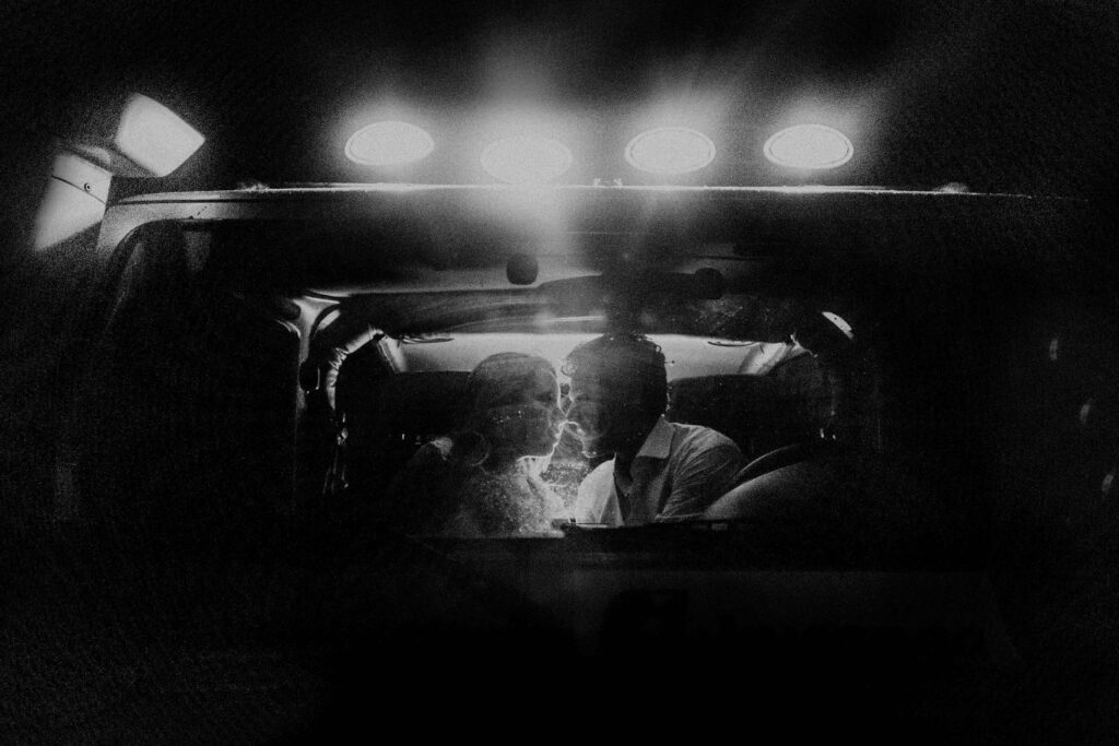 Romantic Black and White Car Wallpaper: Intimate Couple Moment