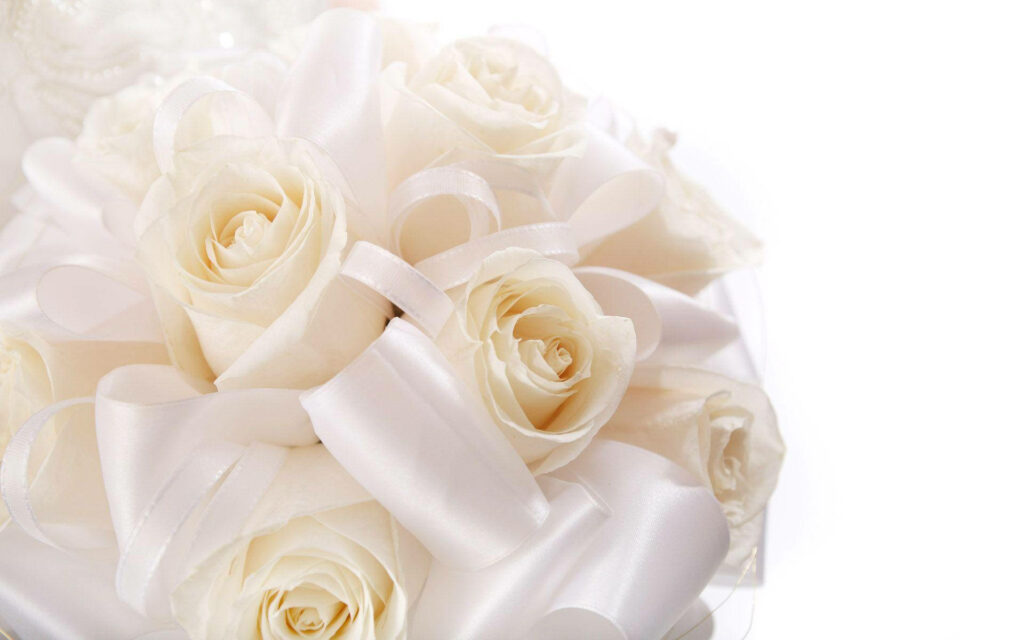 Elegant Wedding Blooms: Serene Close Up of White Rose Bouquet with Satin Ribbons Wallpaper