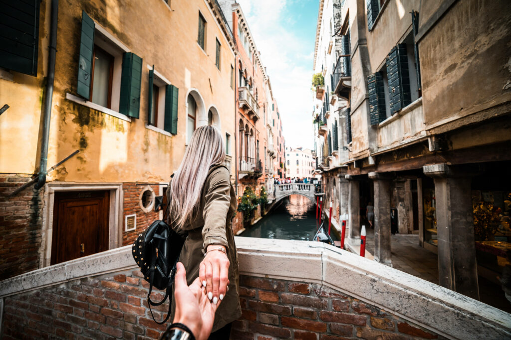 Romantic Escape: Exploring Venice's Enchanting Streets Hand in Hand Wallpaper