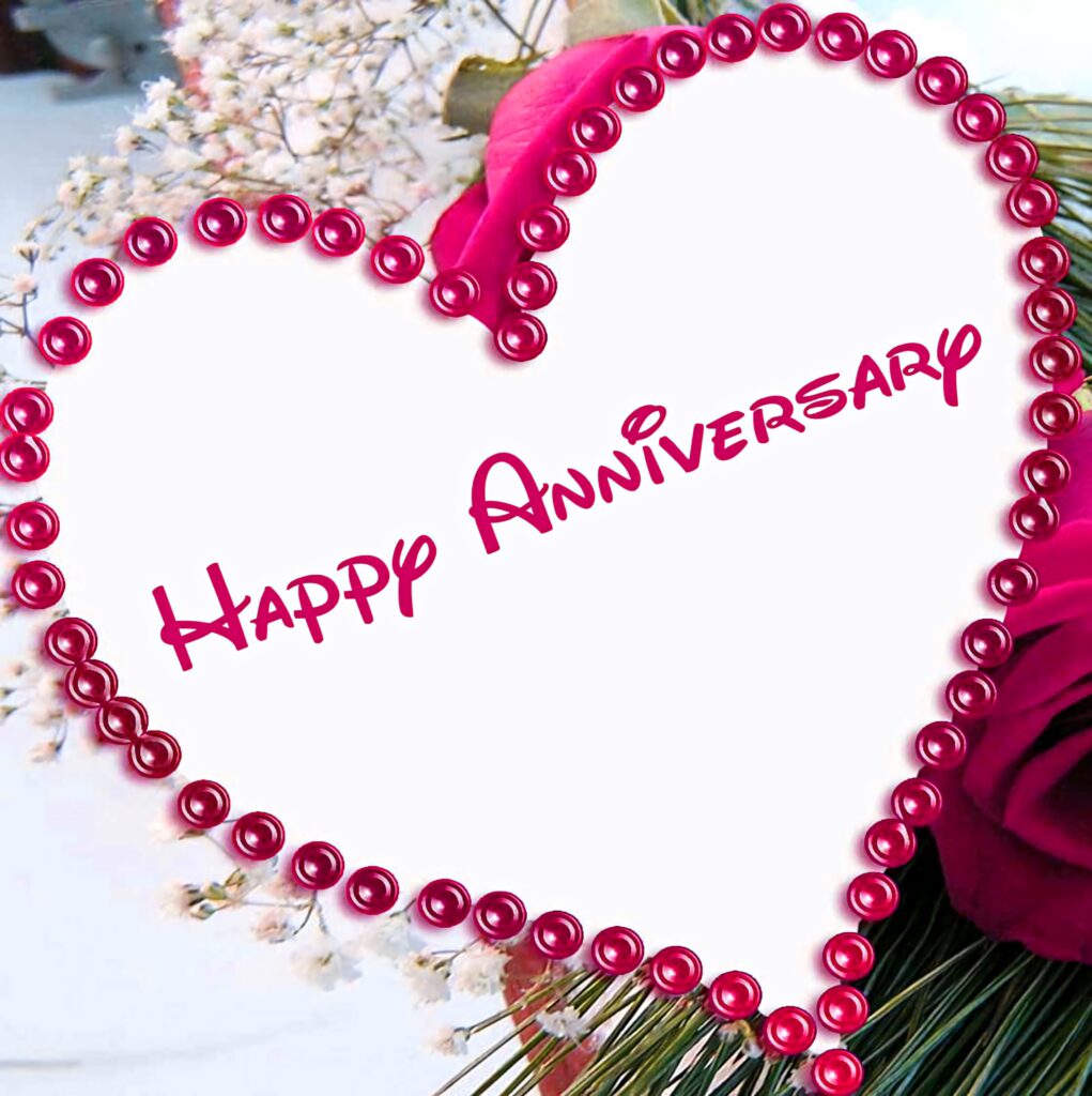 Heart-shaped anniversary cake with pink pearls surrounded by red roses romantic wallpaper background