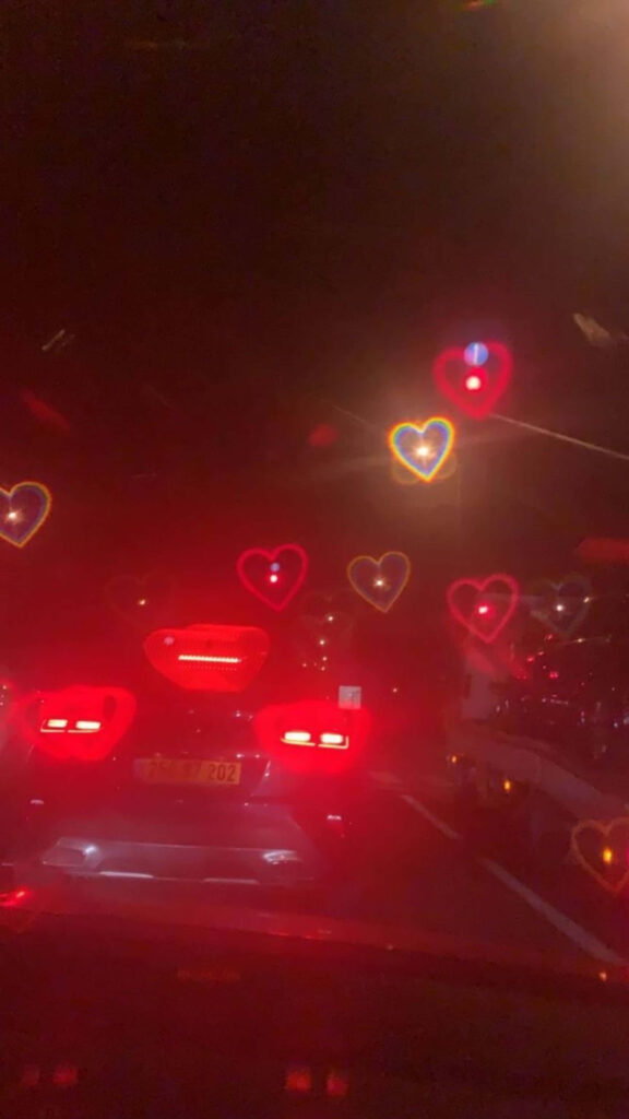 Dreamy Night Car Ride Wallpaper with Glowing Heart Windshield