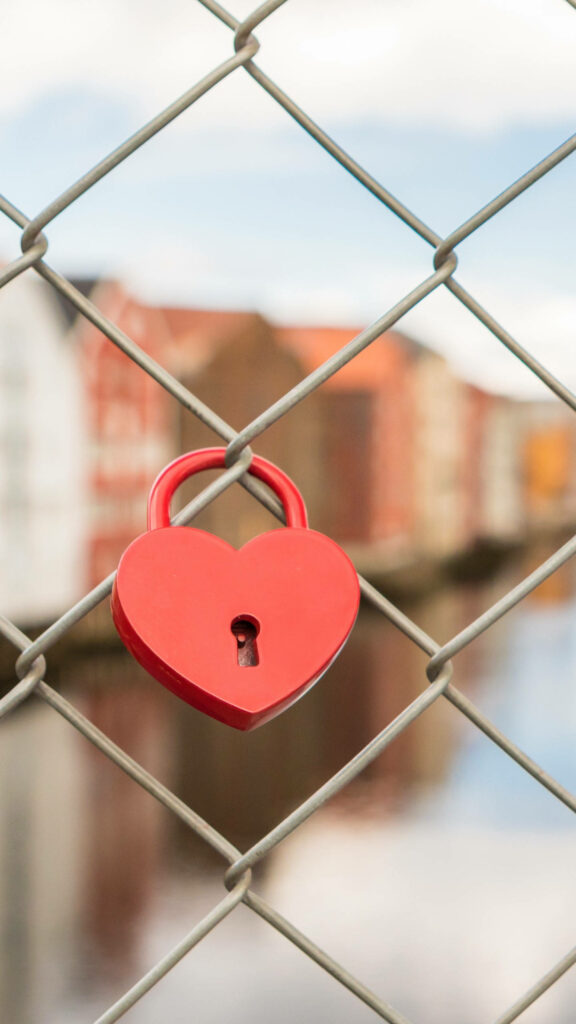 Whimsical Heart Lock Wallpaper: Romantic Fence & Scenic Background