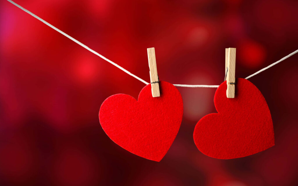 Romantic Red Heart Cutouts Wallpaper Background with Soft Blurred Effect