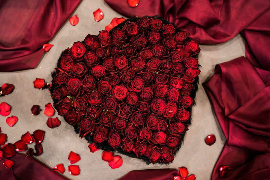 Elegant Red Roses Heart Wallpaper on Burgundy Fabric Background
