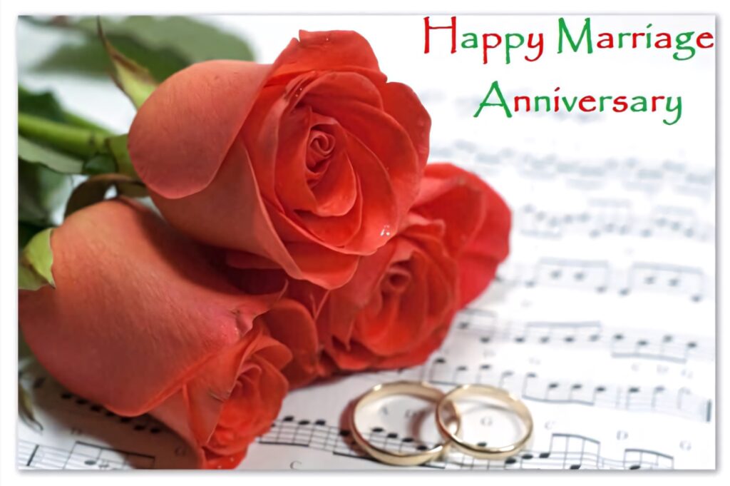 Romantic anniversary wallpaper with red roses gold wedding rings on sheet music celebrating love