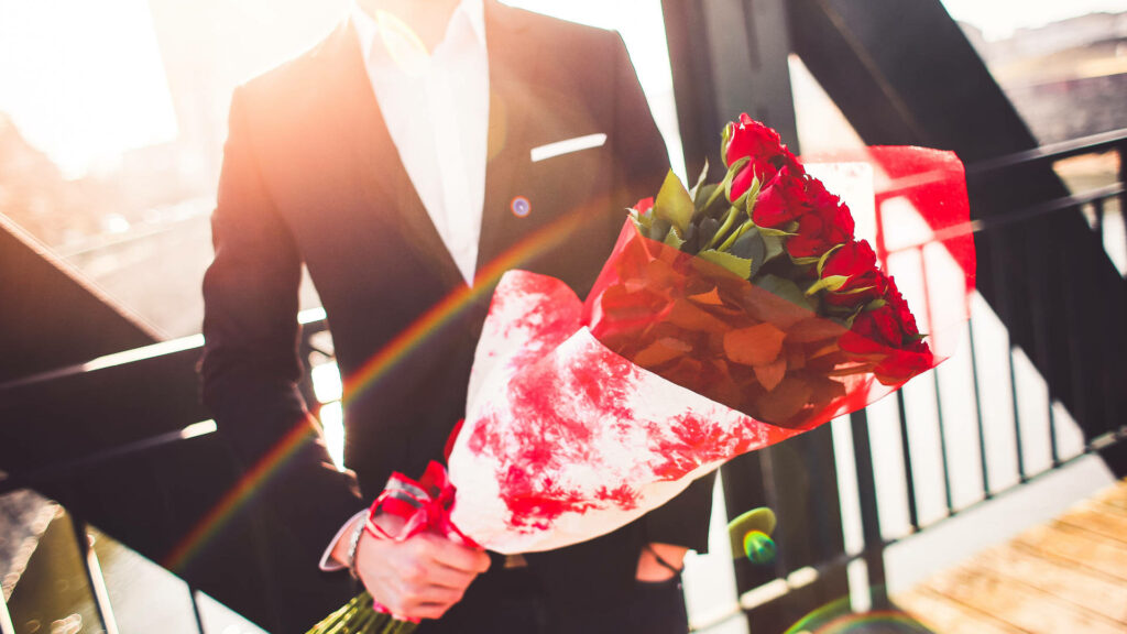 Elegant Suit with Vibrant Red Roses: Romantic Celebration Scene Wallpaper
