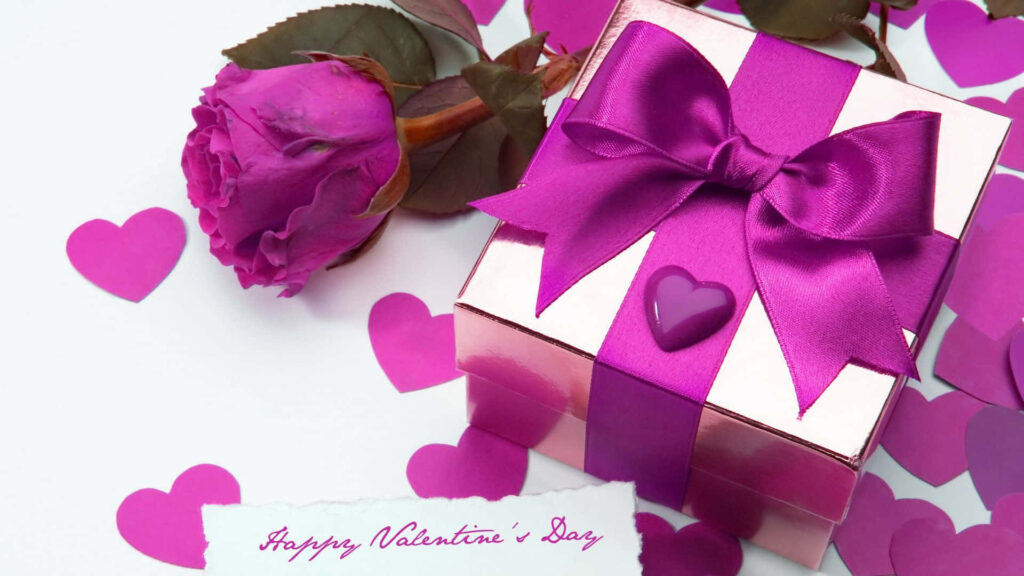 Romantic Valentines Day gift box with purple ribbon rose and heart confetti on wallpaper background