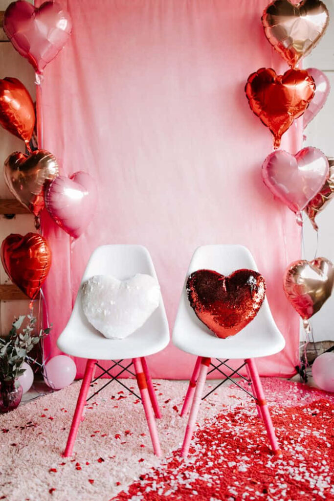Romantic Valentine's Setup: White Chairs & Heart Balloons Wallpaper
