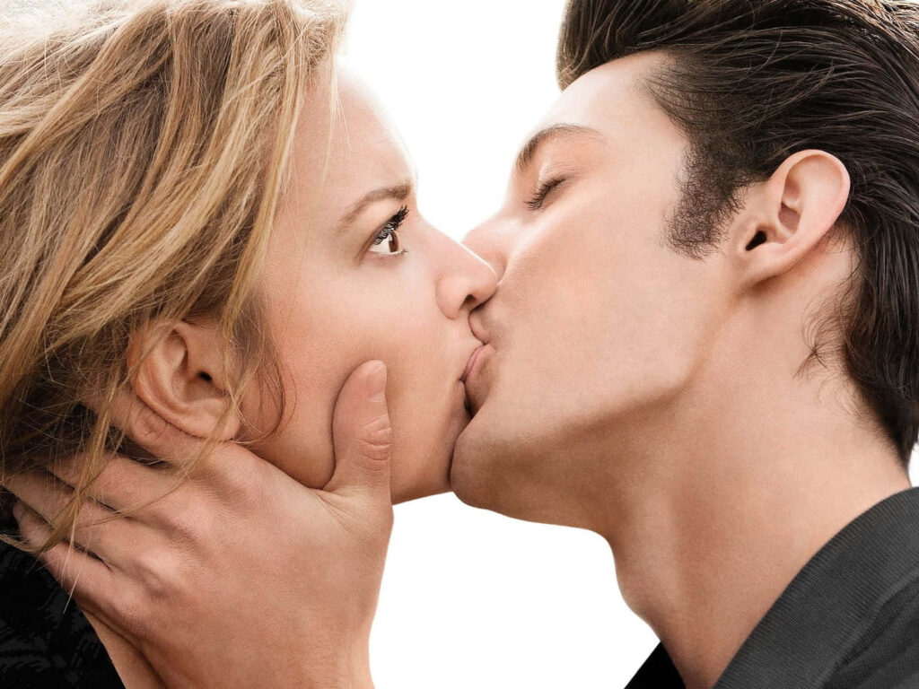 Handsome man tenderly kissing woman lips intimate romantic moment wallpaper background