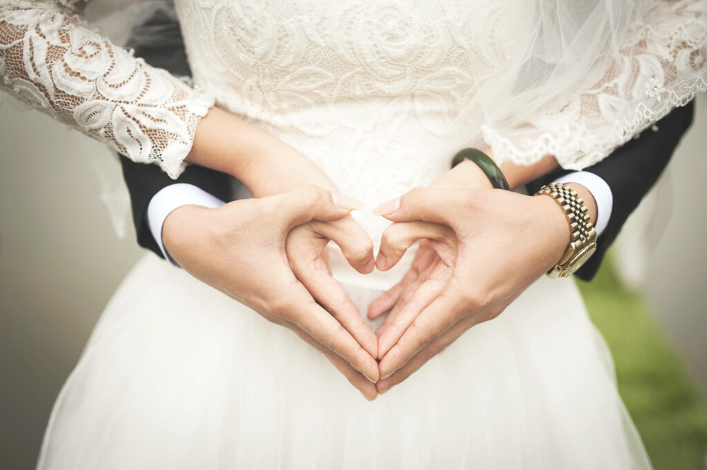Romantic Wedding Wallpaper: Couple Forming Heart with Hands