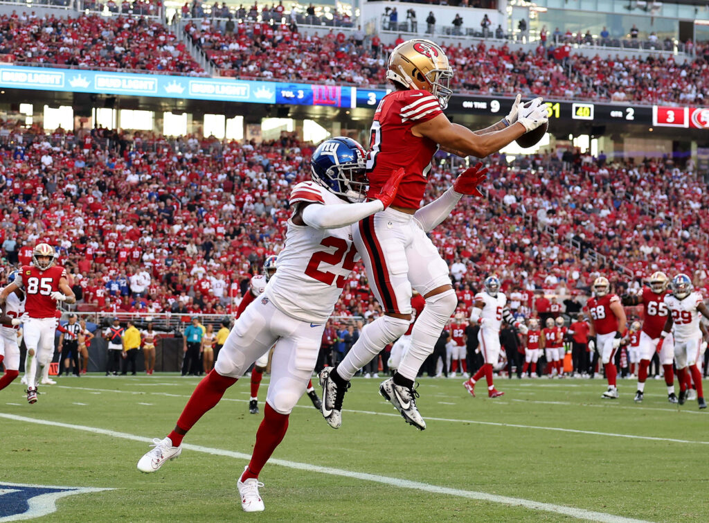 Ronnie Bell 49ers leaping touchdown catch vs Giants Deonte Banks in vibrant NFL stadium action Wallpaper