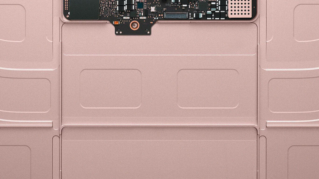 Close-up of rose gold MacBook circuit board showcasing sleek tech design and engineering detail Wallpaper
