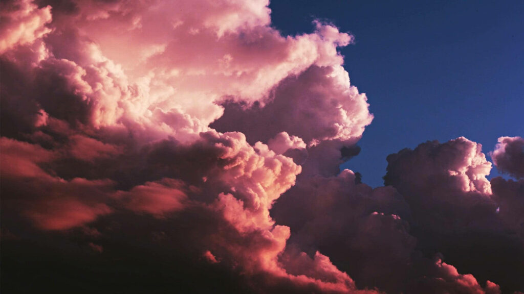 Rose pink sunset clouds over deep navy sky high resolution serene wallpaper background