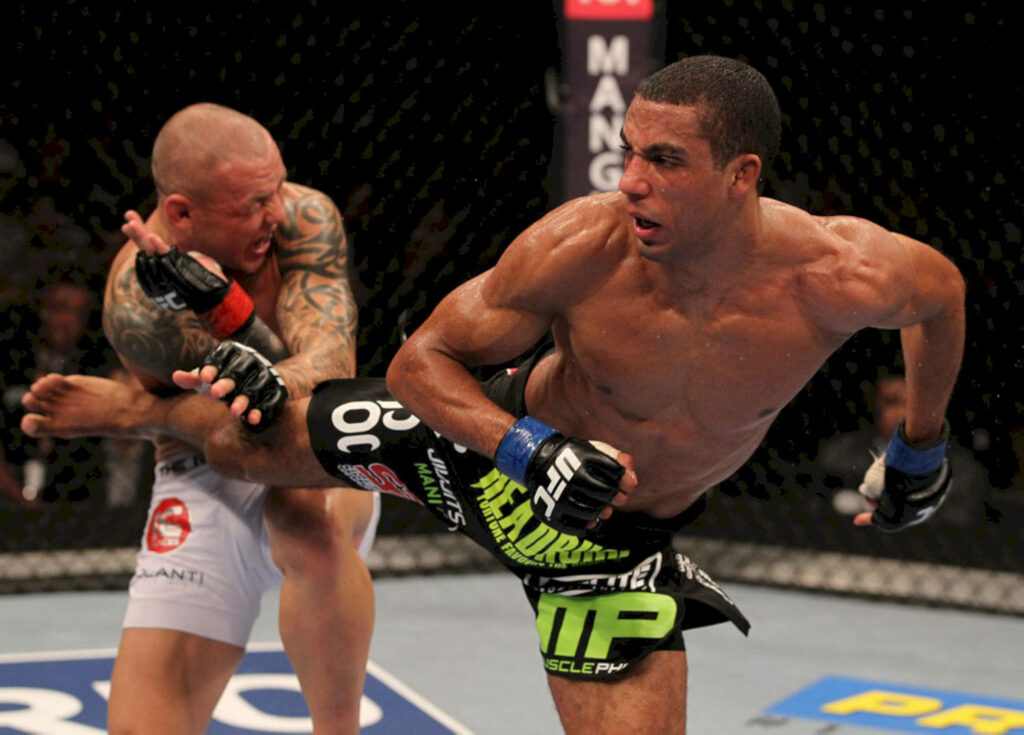 Ross Pearson blocks Edson Barboza's powerful kick in intense UFC fight showcasing MMA strength Wallpaper