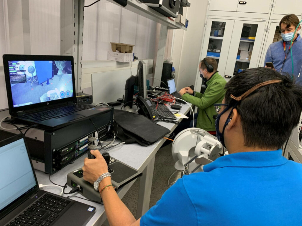 Rover Operator in Lab: Team Collaboration with Advanced Equipment Wallpaper