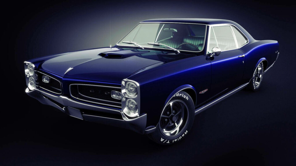 Royal blue Pontiac GTO muscle car with classic design and sleek lines on dark background wallpaper