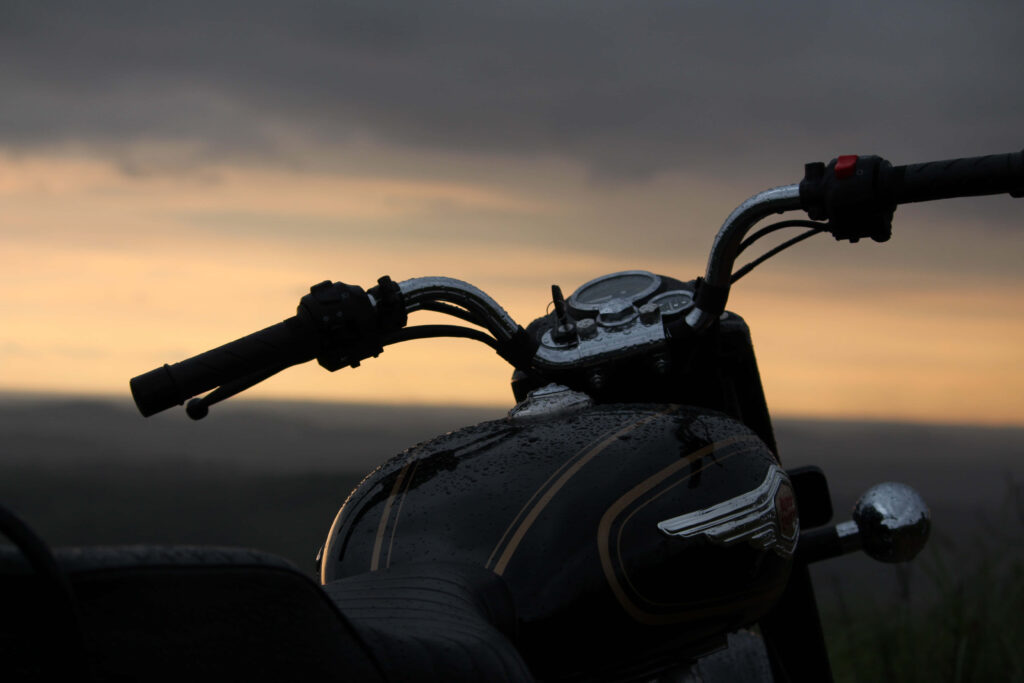 Classic Royal Enfield Motorcycle Wallpaper at Sunset with Water Droplets