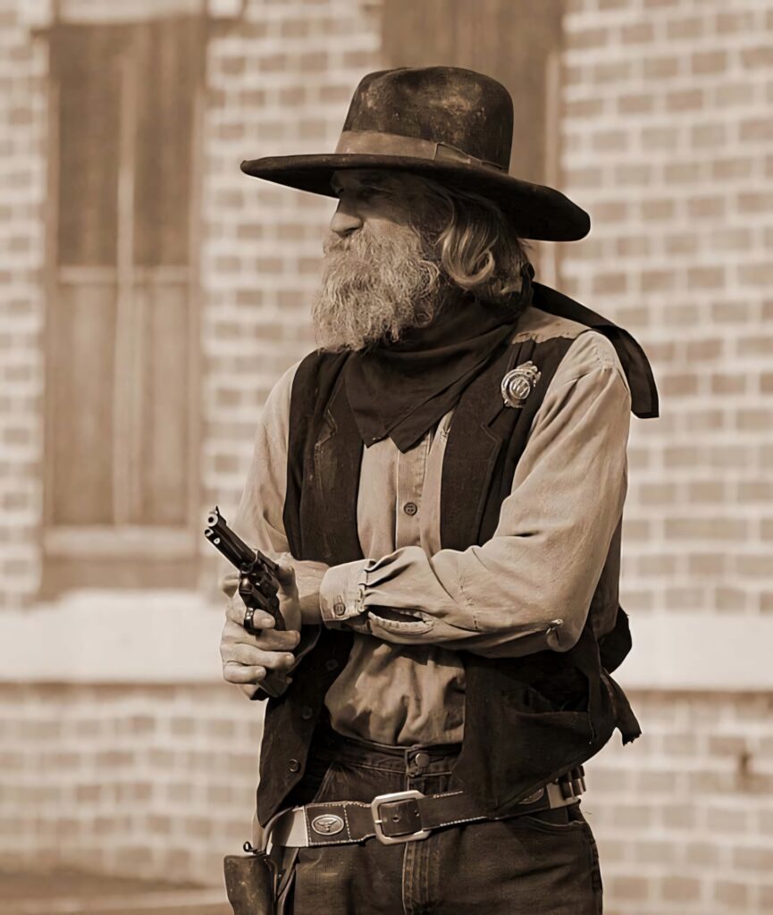 Rugged cowboy in classic Western attire with revolver against sepia Wild West brick backdrop Wallpaper