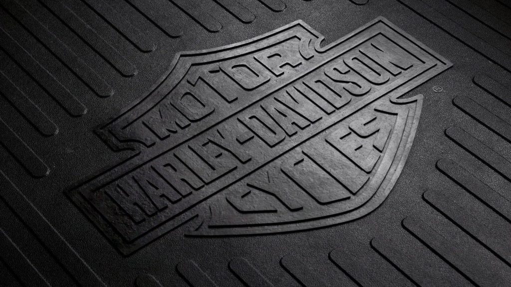 Harley-Davidson Motor Cycles embossed logo on textured black rubber mat with industrial design Wallpaper
