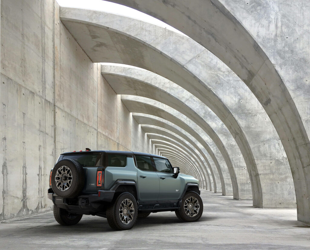 Rugged Hummer Wallpaper Amidst Striking Architectural Structures