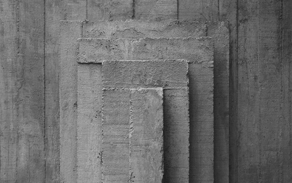 Textured concrete wallpaper with stacked rectangular slabs in a modern industrial design background
