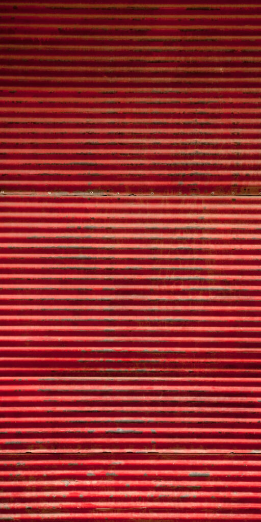 Rugged Red Textured Metal Wallpaper Background with Horizontal Ridges