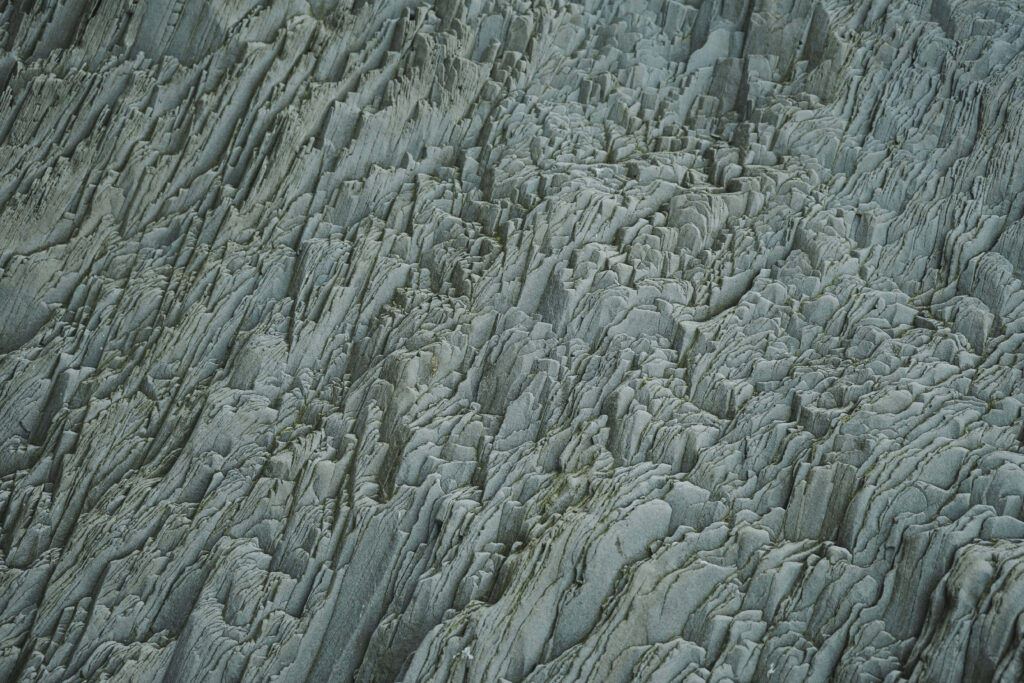 Rugged Rock Formation Close-Up: Textured Erosion Patterns Wallpaper