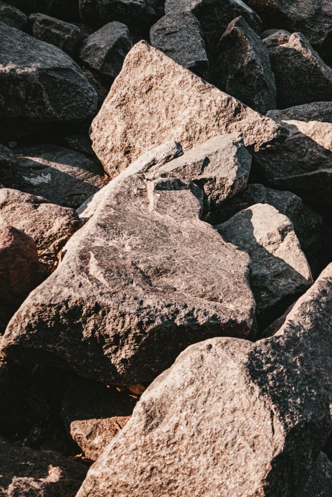 Close-up of rugged rocks with coarse textures and natural earthy tones for rustic backgrounds Wallpaper
