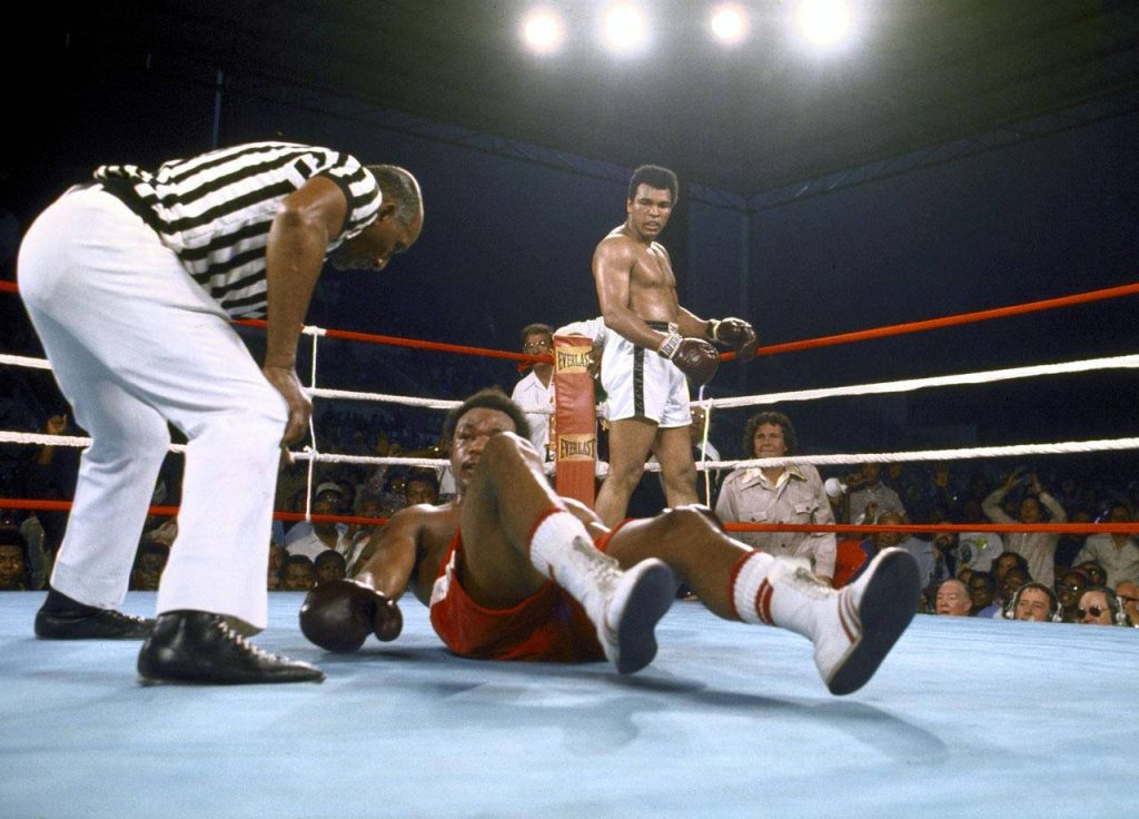 Muhammad Ali standing over George Foreman in Rumble in the Jungle 1974 boxing match wallpaper