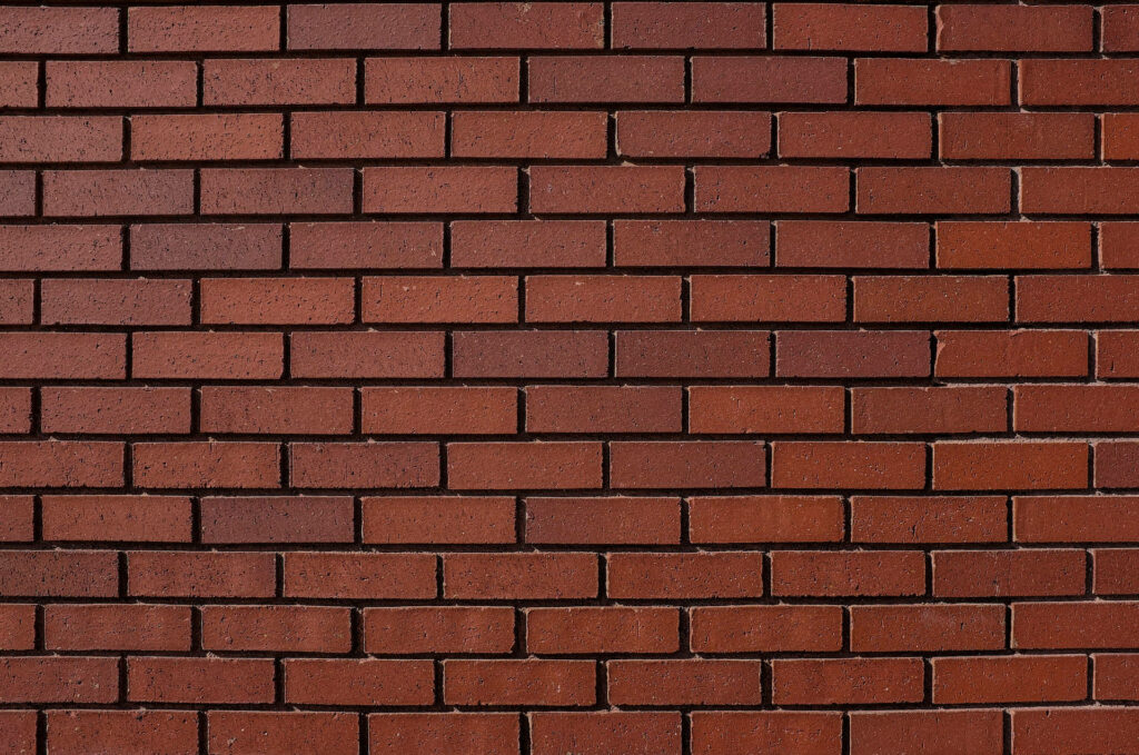 Rustic dark brown brick wall wallpaper with textured running bond pattern for modern interiors