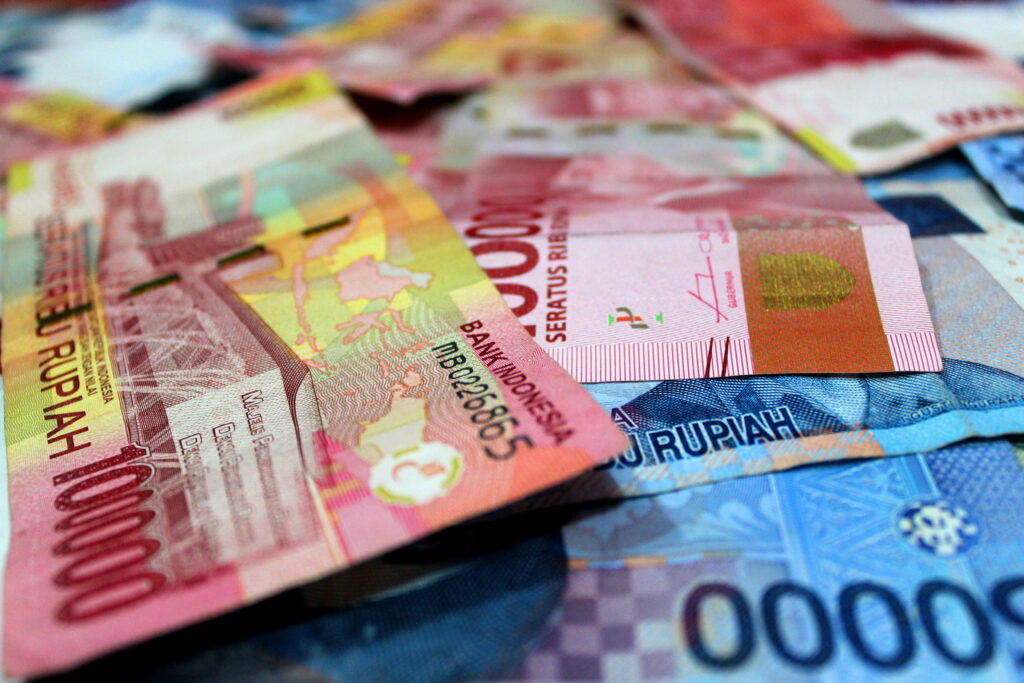 Macro photo of vibrant Indonesian Rupiah banknotes 100000 and 50000 IDR detailed texture background Wallpaper