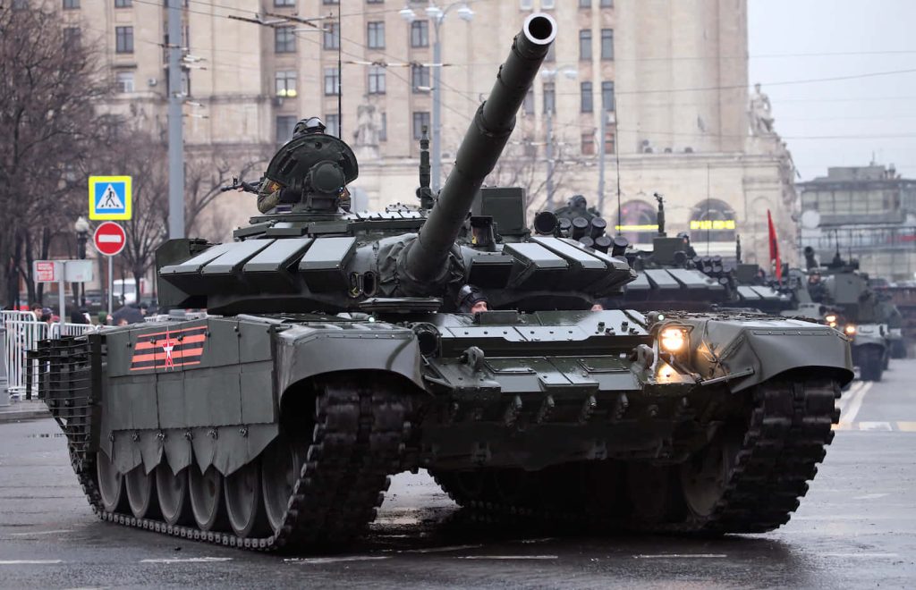 Russian T-72B3 battle tank with reactive armor and Guards ribbon on city street parade Wallpaper