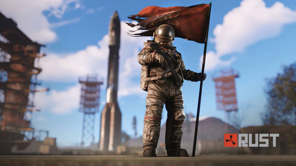Rust game wallpaper space-suited survivor with tattered flag before Launch Site rocket under blue sky