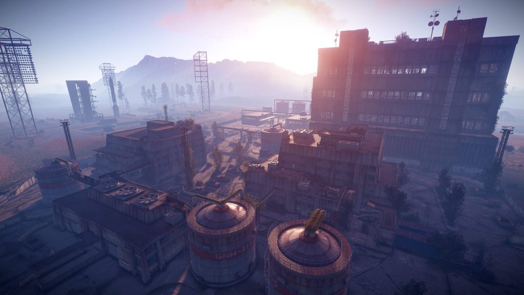 Post-apocalyptic Rust Power Plant monument with industrial tanks under golden sunset sky Wallpaper