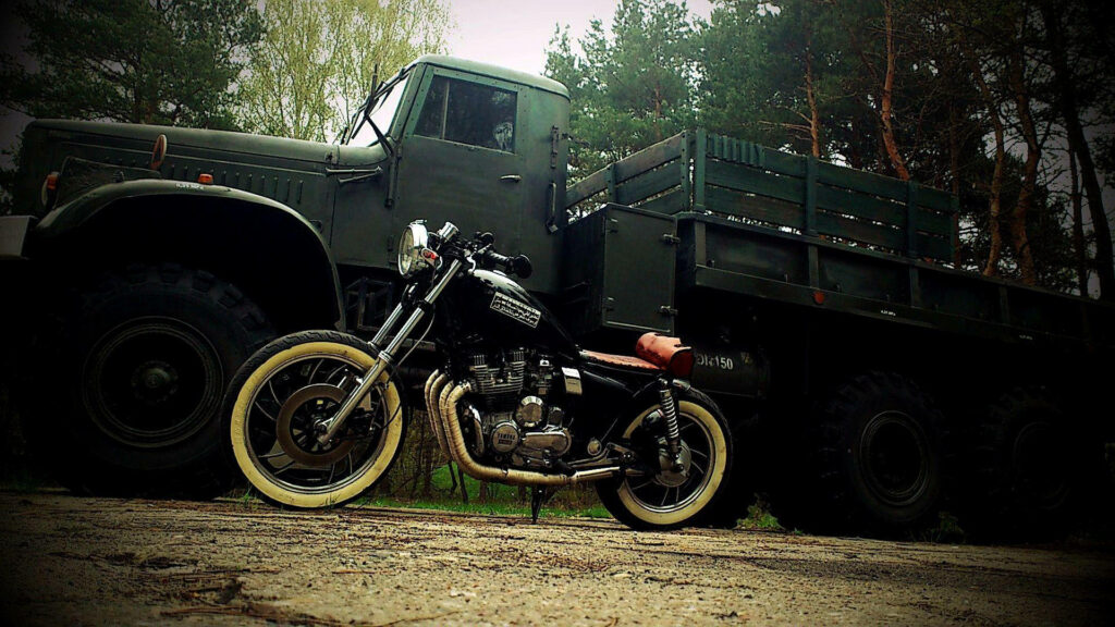 Rustic Adventure Wallpaper: Bobber Motorcycle & Army Truck in Nature