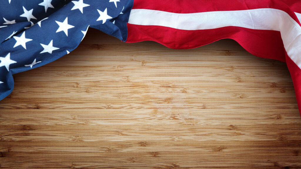 American flag draped on rustic natural wood background patriotic wallpaper symbolizing strength