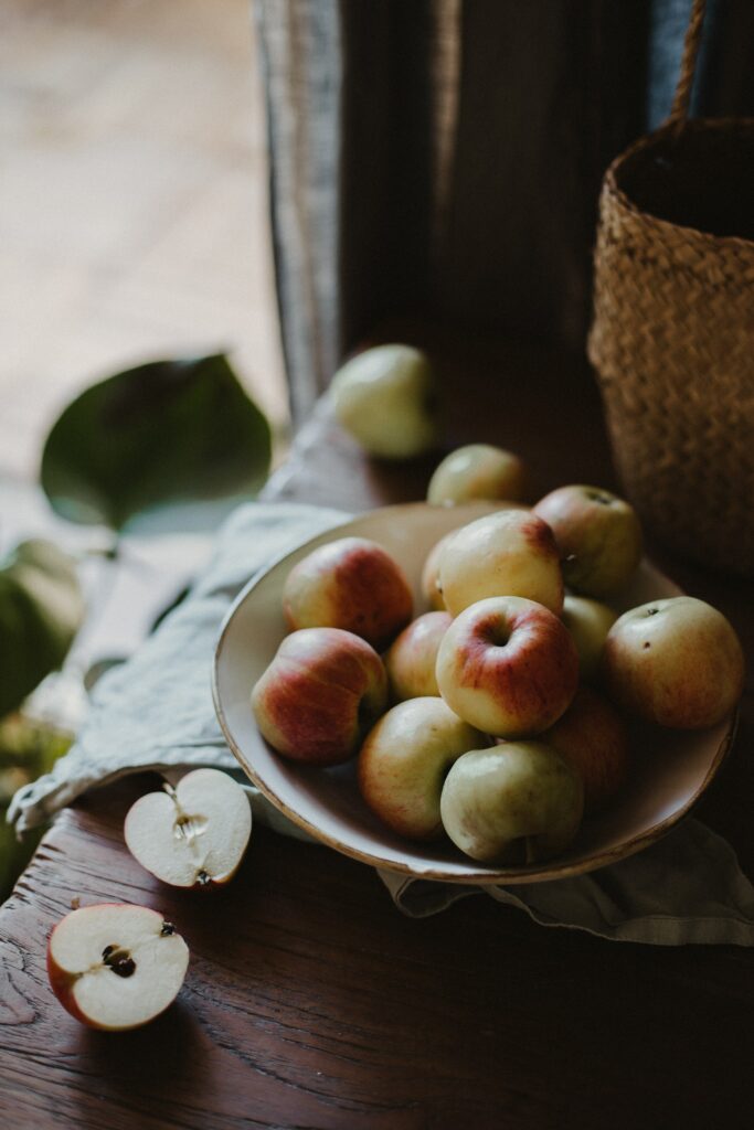 Rustic Apple Bowl Wallpaper: Fresh Fruit on Wooden Table in Natural Light