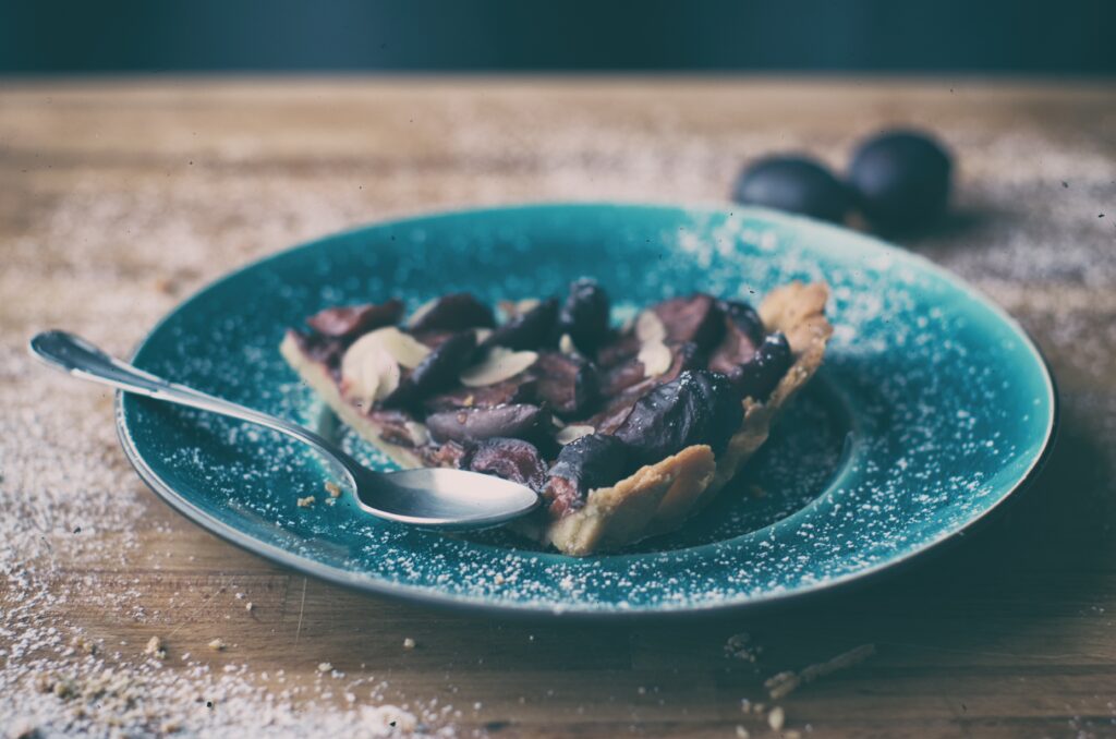 Rustic Baked Plum Pie on Blue Plate - Charming Wallpaper Background
