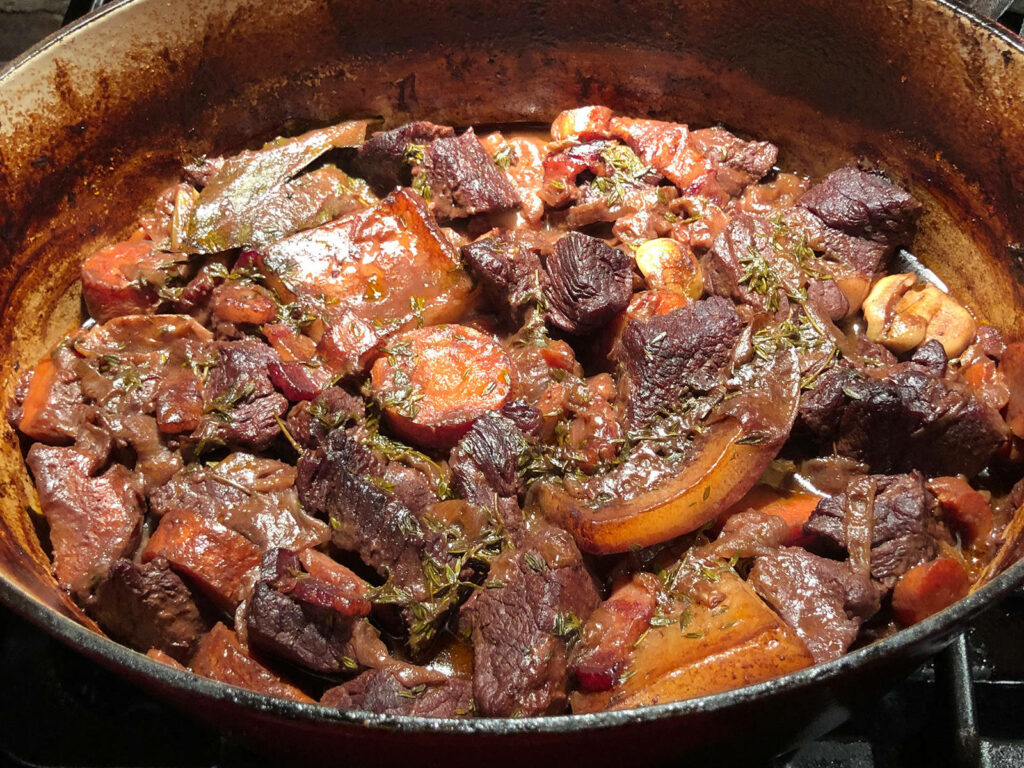 Rustic Beefy Bourguignon: Hearty Dish in Cooking Pan Wallpaper