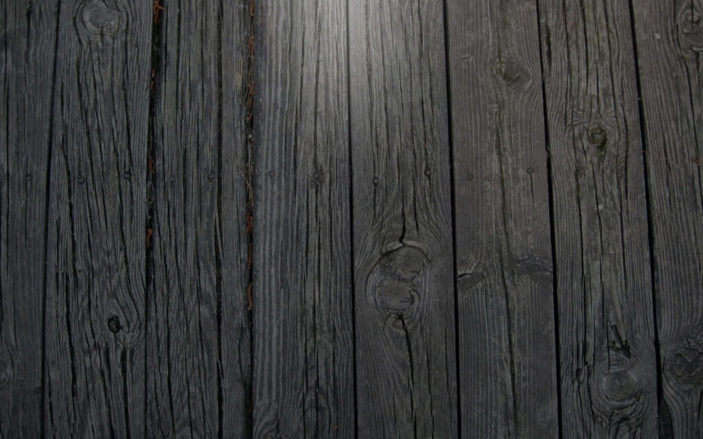 Rustic Black Wooden Plank Wallpaper with Natural Grain Patterns