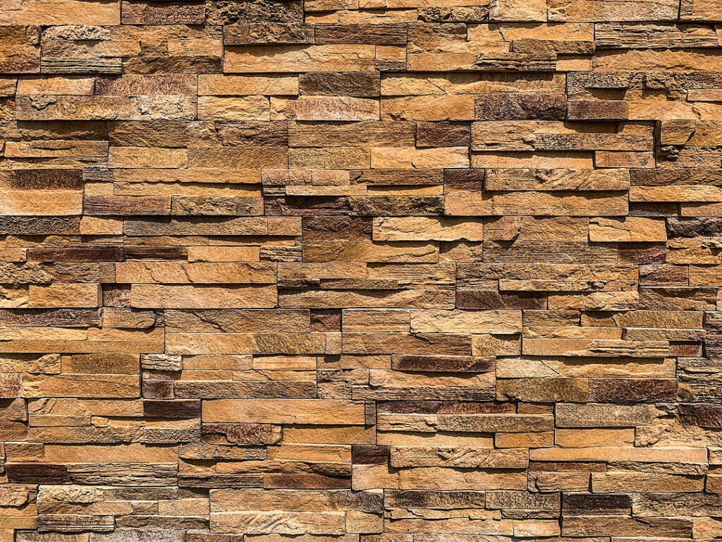 Rustic Warm Yellow and Brown Textured Brick Wall Wallpaper Background