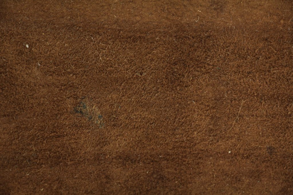 High-resolution brown leather suede wallpaper with rich earthy tones and soft fibrous texture