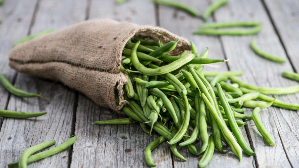 Rustic Brown Sack of Fresh Green Beans on Weathered Wood Wallpaper