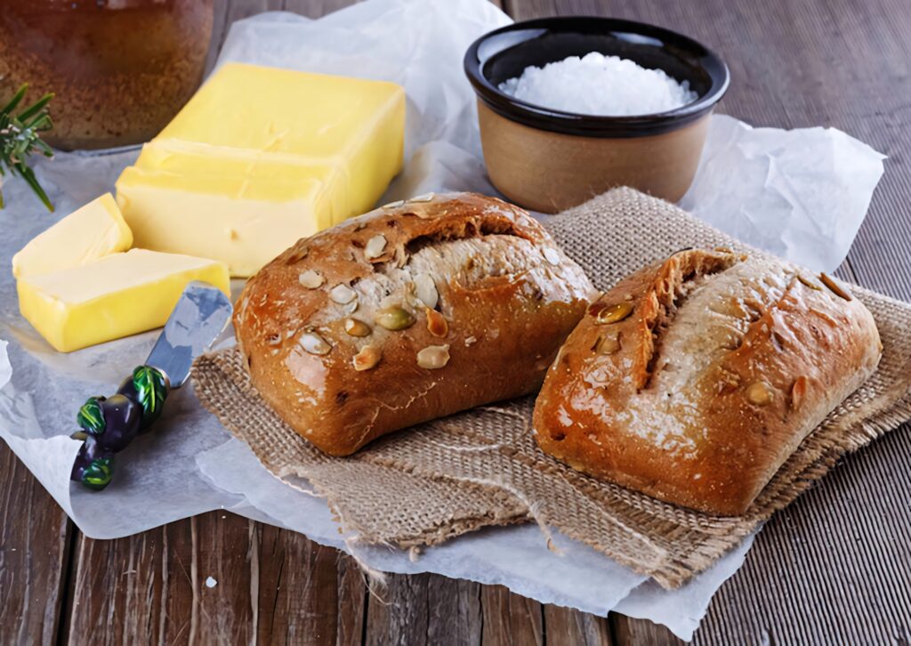 Rustic whole grain bread with seeds butter and flour on burlap mat farmhouse kitchen wallpaper