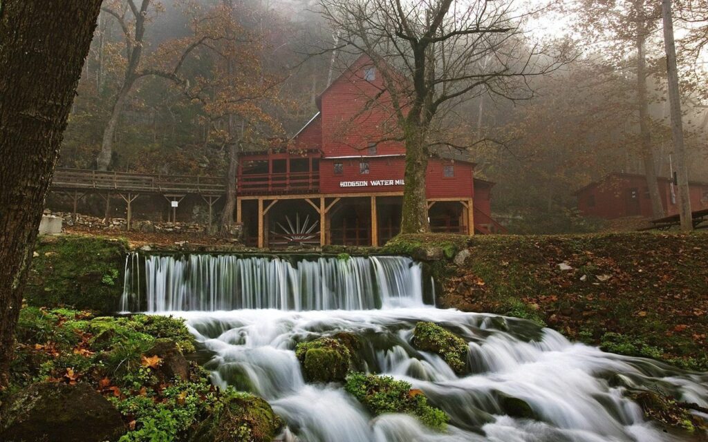 Rustic camp by cascading waterfall autumn trees mist peaceful nature wallpaper background