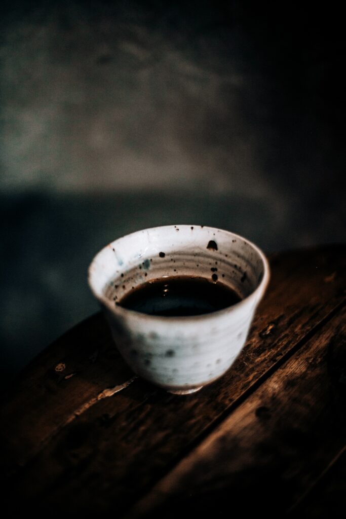 Rustic Ceramic Coffee Cup on Wood - Warm Serene Wallpaper